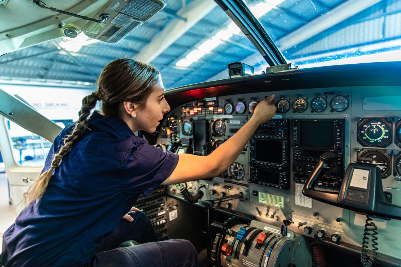 Pilot checking airplane cockpit instruments.