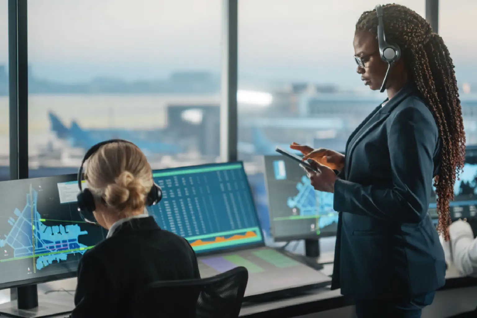 Control tower staff monitoring flight data