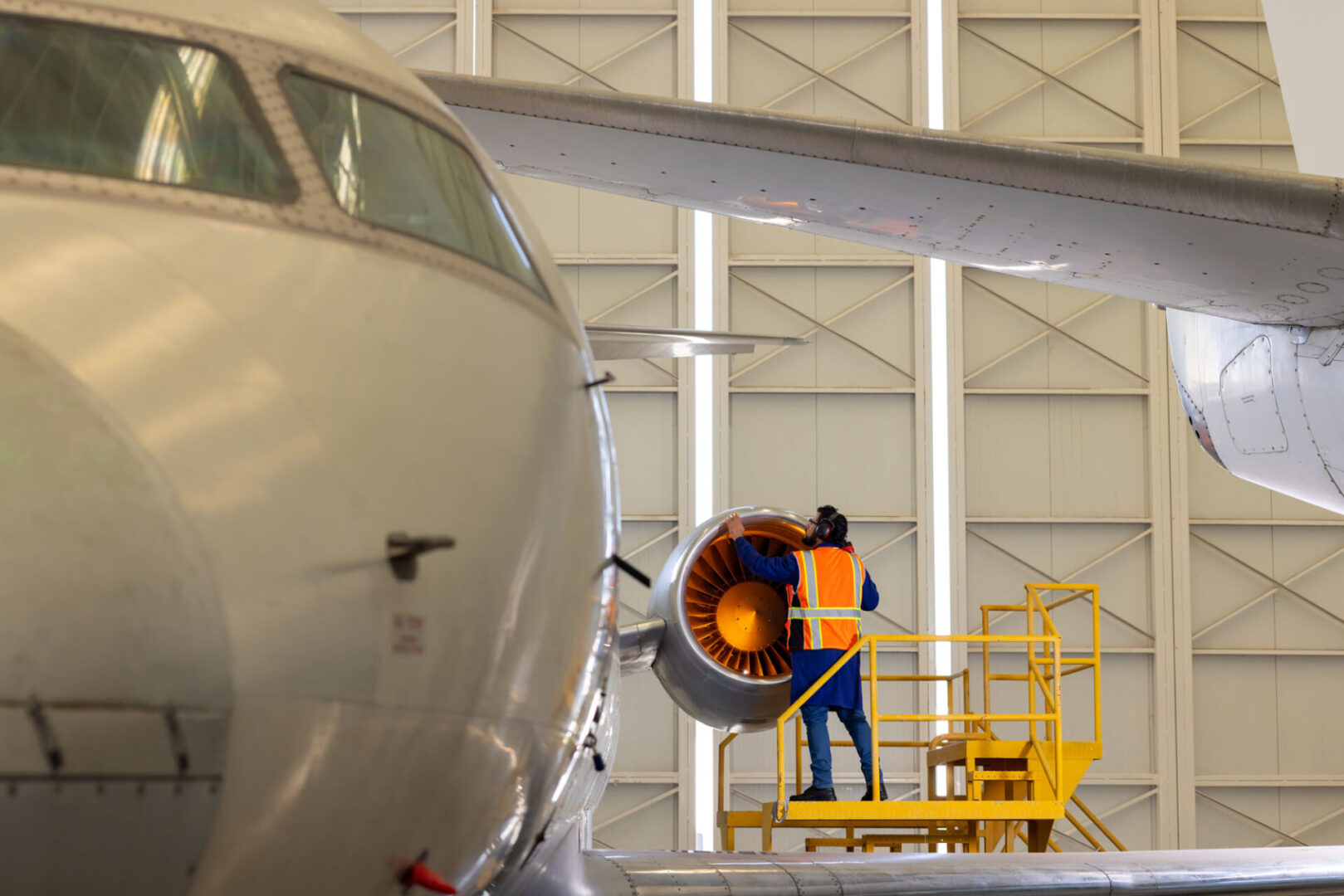 Technician inspecting airplane engine