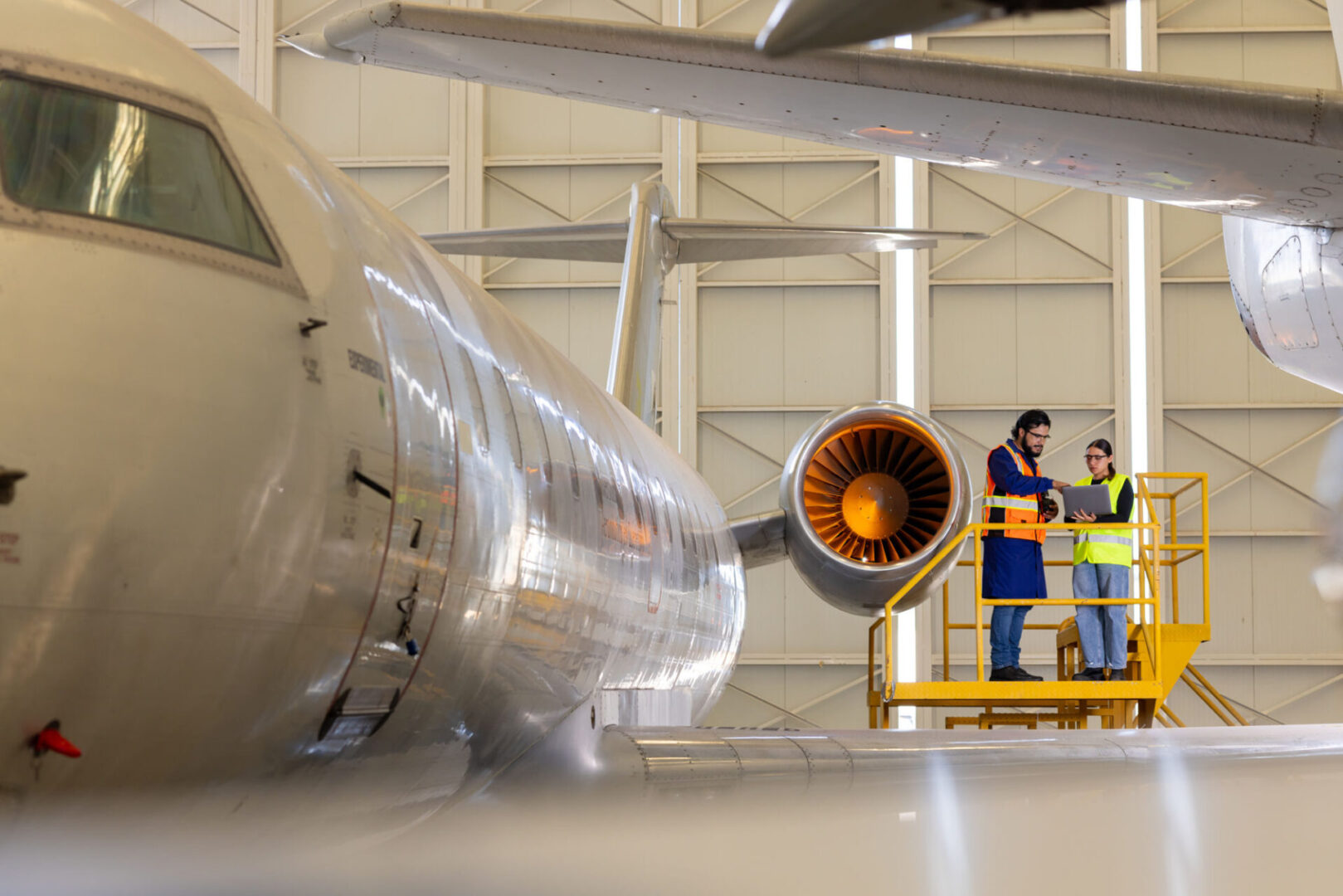 Engineers inspecting airplane engine
