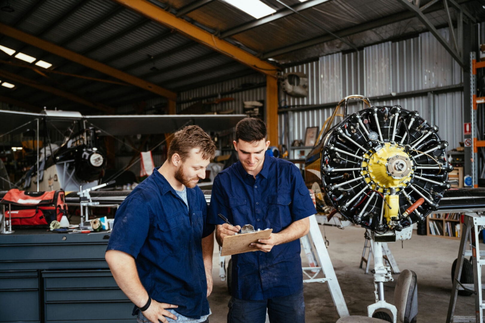 Mechanics discussing aircraft engine maintenance